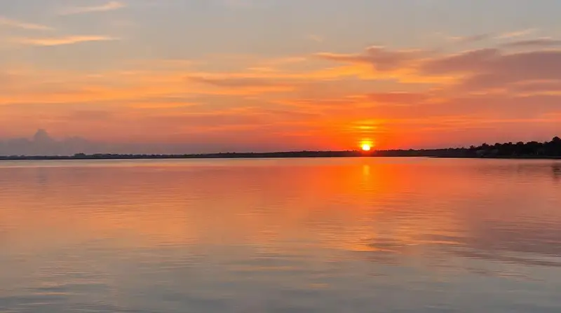 Orange sunset reflecting on calm water along the Indian River
